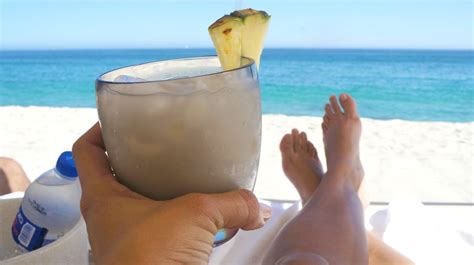 Sipping a coconut margarita on the beach at Grand Velas Los Cabos resort - Honey + Lime