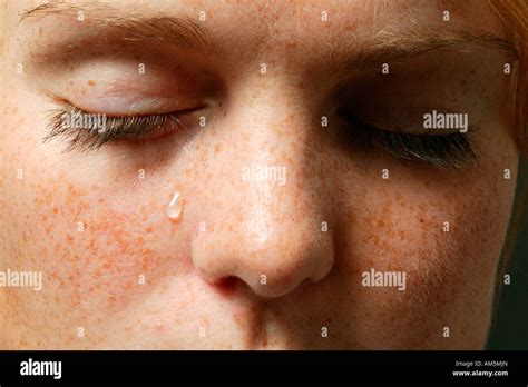 Eyes with a teardrop Stock Photo - Alamy