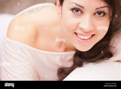 this Italian brunette has big brown eyes and is softly relaxing on this white living room ...