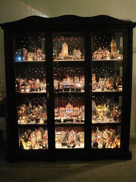 Christmas village displayed in a curio cabinet with led mini lights for stars | Christmas ...