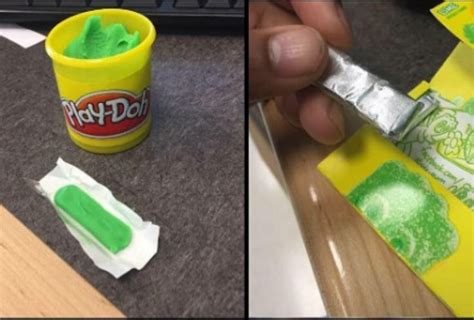 a person holding a green object in their left hand and next to a yellow cup filled with play - doh