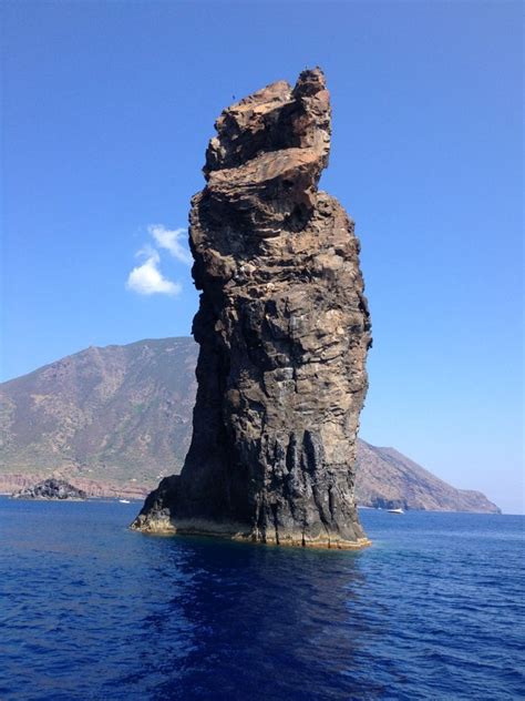 a large rock sticking out of the ocean