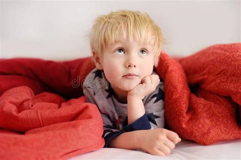 Cute Little Boy in Pajamas Having Fun in Bed after Sleeping and Watching TV or Dreaming Stock ...