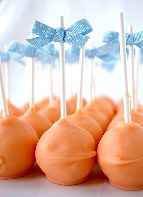 orange cake pops with blue bows on them
