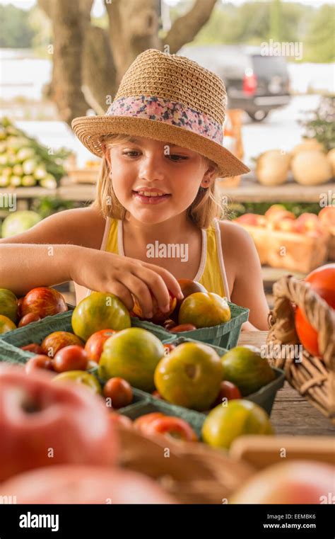 Mixed race girl browsing produce at farmers market Stock Photo - Alamy