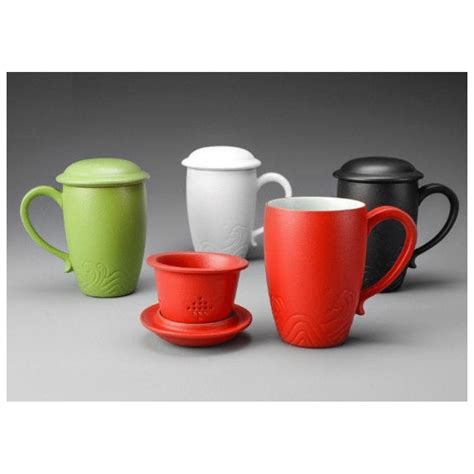 four different colored coffee cups and saucers
