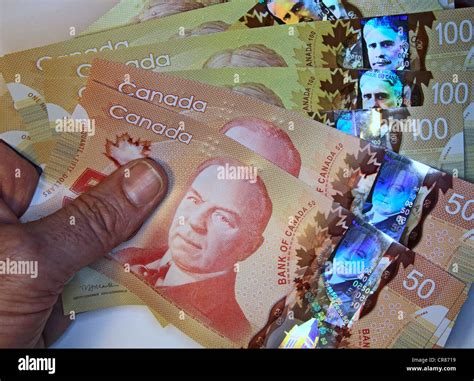 Canada's new anti-counterfeiting polymer banknotes Stock Photo - Alamy