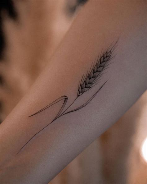 Wheat tattoo located on the inner forearm.