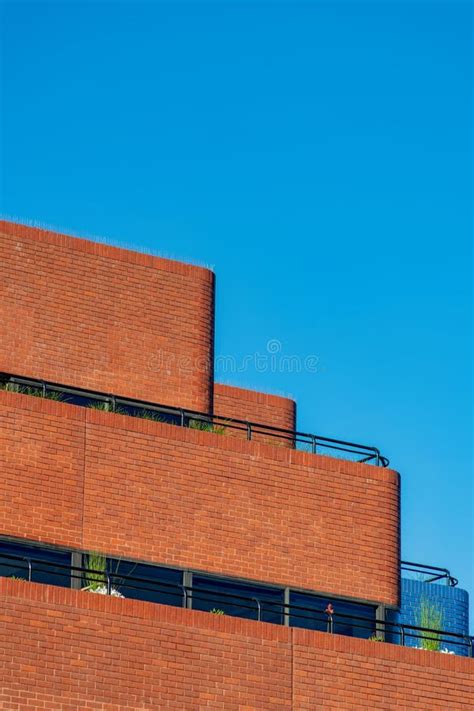Stair Step Style Building Terrace with Clear Blue Sky Background of Brick with Visible Windows ...
