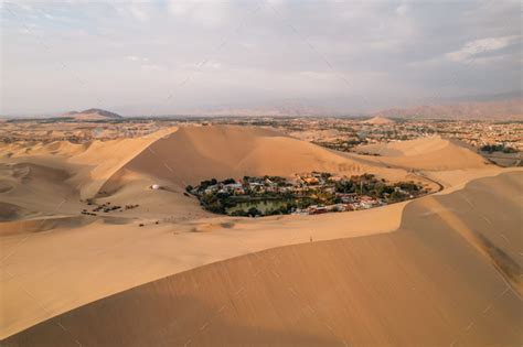 Aerial sunset photo of desert oasis Huacachina, Ica, Peru, South America Stock Photo by petero31