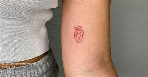 Fine line anatomical heart tattoo in red ink