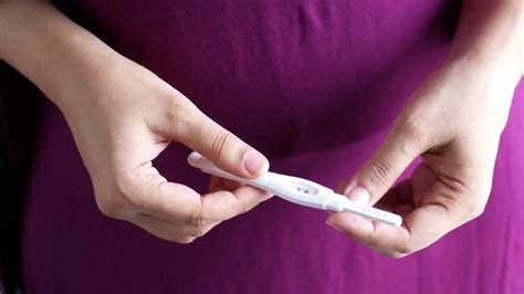 Hand Holding Pregnancy Test Kit on a Wood Desk, Stock Video - Envato Elements