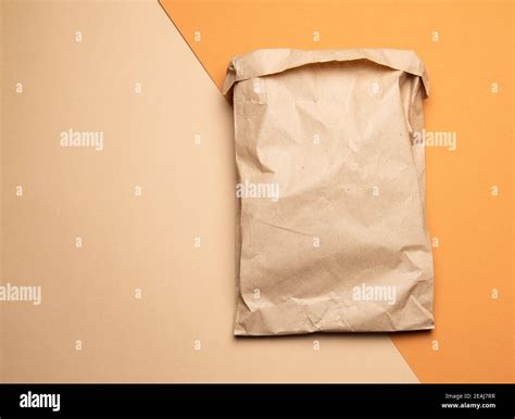 brown paper disposable food bag on a orang background Stock Photo - Alamy
