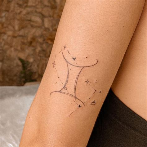 Fine line Gemini symbol and constellation tattoo on the