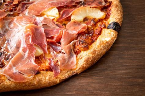 Premium Photo | Pizza with prosciutto or parma ham pizza