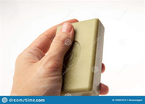 A Bar of Natural Green Soap in Hand Isolated on White Background ...