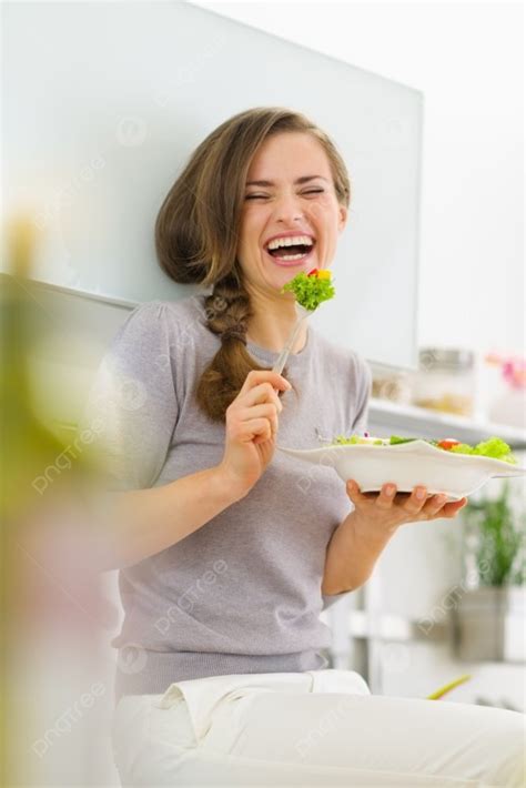 Smiling Young Woman Eating Fresh Salad In Modern Kitchen Photo Background And Picture For Free ...