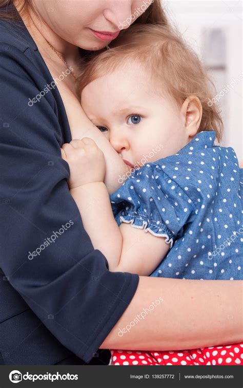 Mom breast feeding baby girl Stock Photo by ©Alexander_Safonov 139257772