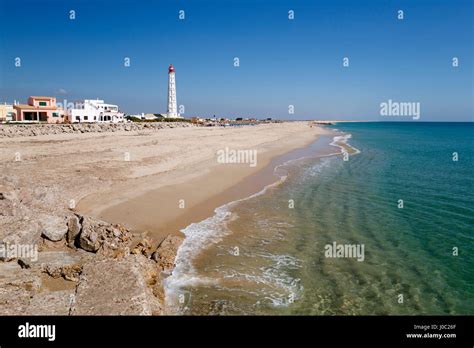 Lighthouse and beach of Ilha do Farol, Culatra barrier island, Olhao ...