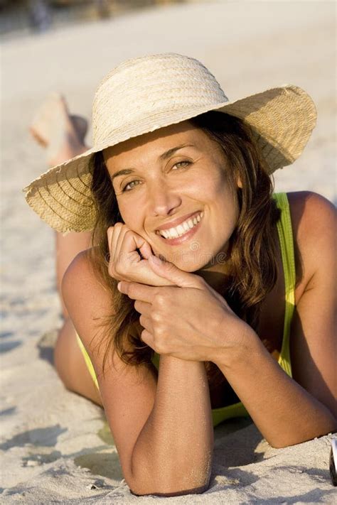 Smiling Woman in the sand stock photo. Image of smiling - 111037814