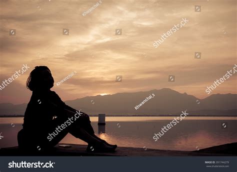 Silhouette Young Girl Sitting Sunset Against Stock Photo 391744279 | Shutterstock