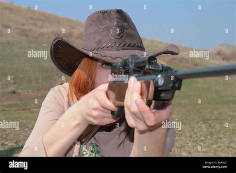The young woman with rifle is shooting Stock Photo - Alamy