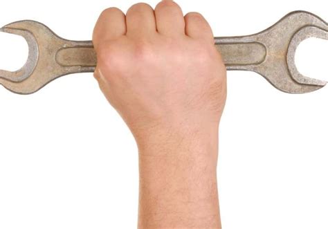 a hand holding a wrench with both hands