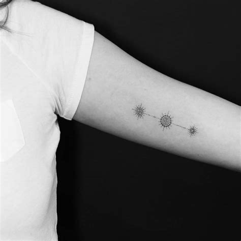 Orion's belt tattoo on the left inner arm.