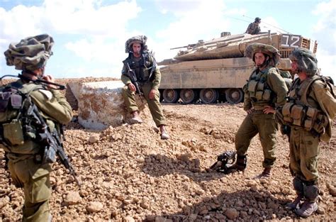 Israeli soldiers wearing Mitznefet helmet cover. Merkava Mk 4 tank ...