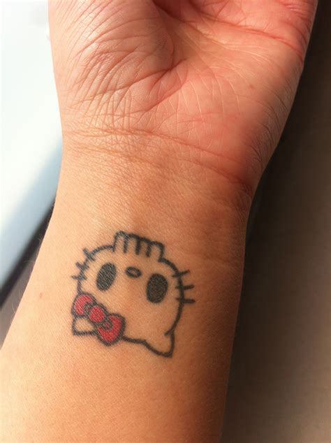 Hello Kitty tattoo on wrist | Hello kitty tattoos, Cute tiny tattoos ...