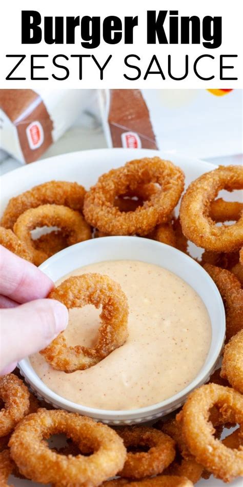 a plate with onion rings and dipping sauce on it, in front of the words ...