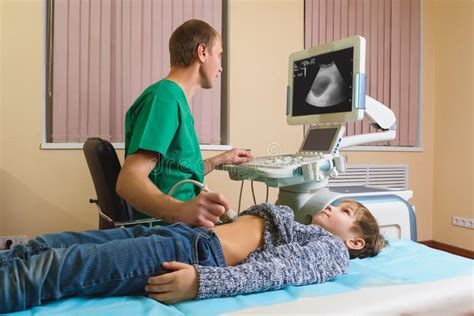 Doctor Analyzing Boy Patient with Abdomen Ultrasound Stock Photo ...