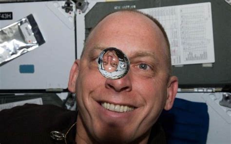 *WATER BUBBLE REFLECTION IN ZERO GRAVITY Photograph by NASA Astronaut Clayton Anderson watches ...