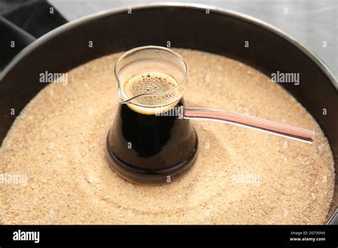 Turkish coffee cooked in sand Stock Photo - Alamy