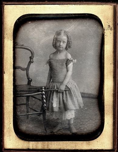 Possibly late 1850s to early 1860s. Child has a stick and ribbon decorated hoop, likely a graces ...