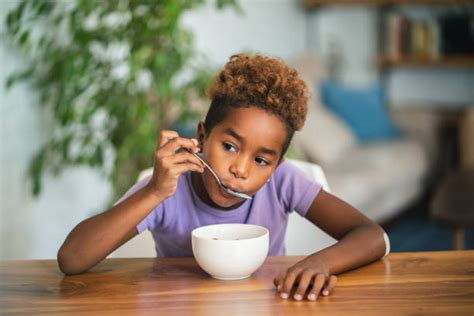 Group Of Kids Eating Cereal