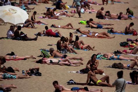 People sunbathe in a beach in Barcelona, Spain, Friday, May 15,... Photo-7998068.109909 ...