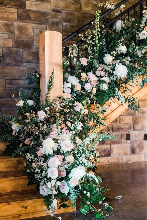 flowers and greenery are arranged on the stairs at this wedding venue in atlanta, ga