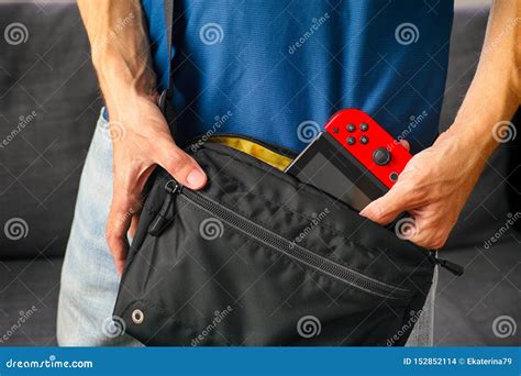 Man Taking Nintendo Switch Video Game Console from Black Bag Editorial Stock Image - Image of ...