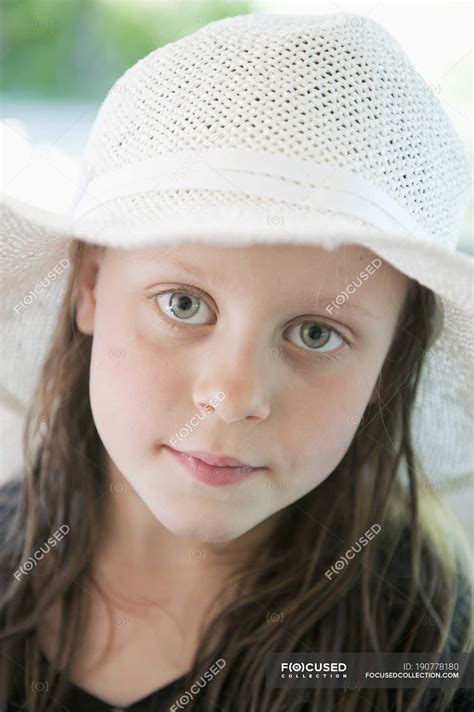 Portrait of girl wearing sun hat, focus on foreground — looking at camera, one - Stock Photo ...