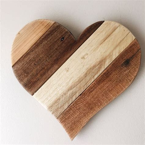 a heart shaped wooden cutting board with two different colored boards on it's sides