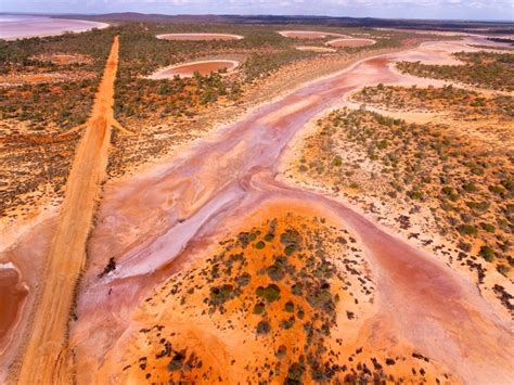 Image of Aerial view of track through salt flats - Austockphoto