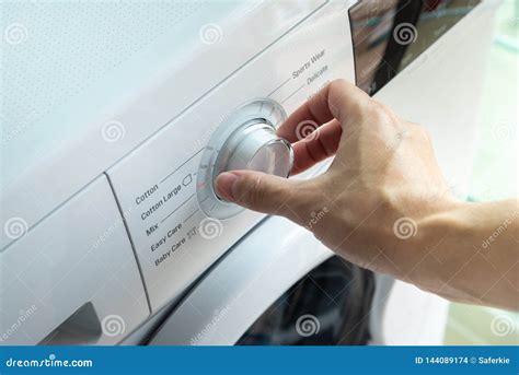 Man Choosing Cycle Program on Washing Machine. Stock Photo - Image of laundry, laundering: 144089174