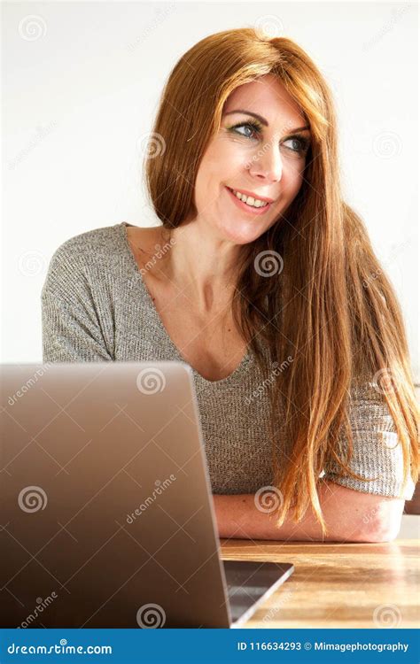 Mature Woman Sitting In Front Of Laptop Smiling Portrait Stock Photo | My XXX Hot Girl