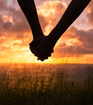 Couple Holding Hands At Sunset Stock Photo - Download Image Now ...