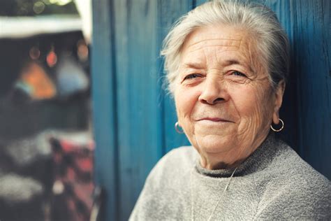 Happy old senior woman smiling outdoor portrait - Hughes Home Care