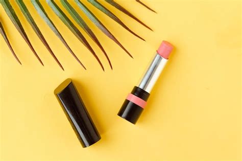 Premium Photo | Pink lipstick on bright yellow background flat lay top ...