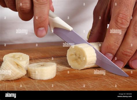 Slicing peeled banana Stock Photo - Alamy