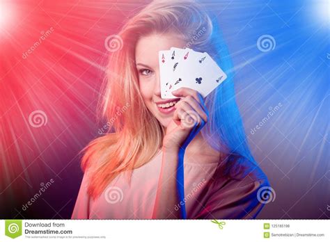 Beautiful Caucasian Woman with Poker Cards Gambling in Casino with Light Rays Shining Over Her ...