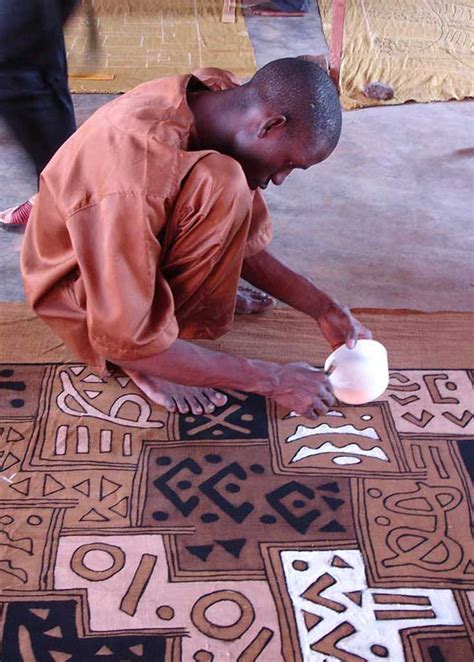 Hand-painting mudcloth in Mali. | Africa art, African textiles, African art